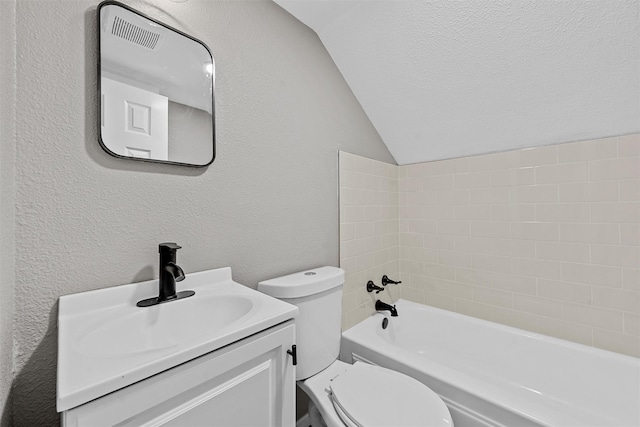 3412 Lisbon Dr, Waco, TX 76706 - bathroom with a textured wall, lofted ceiling, toilet, vanity, and tub / shower combination