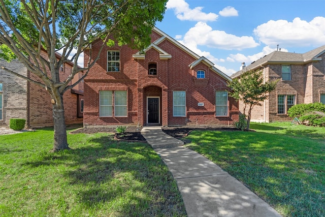 2442 Mackinac Dr, Frisco, TX 75033 - traditional-style house featuring brick siding and a front lawn