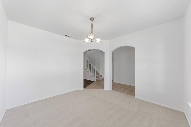 2442 Mackinac Dr, Frisco, TX 75033 - spare room with arched walkways, light carpet, stairway, and baseboards