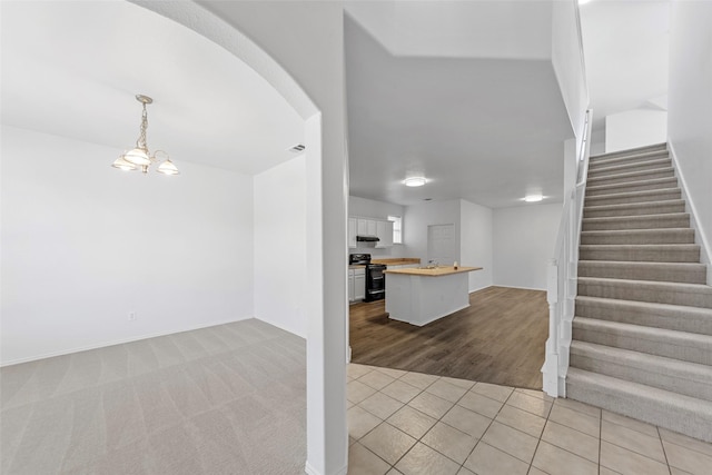 2442 Mackinac Dr, Frisco, TX 75033 - entrance foyer with stairs, light tile patterned floors, arched walkways, a chandelier, and baseboards