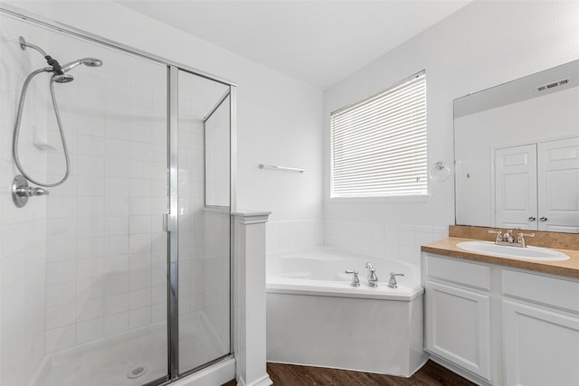 2442 Mackinac Dr, Frisco, TX 75033 - bathroom featuring a shower stall, a bath, vanity, and wood finished floors
