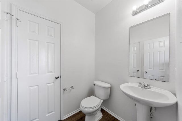 2442 Mackinac Dr, Frisco, TX 75033 - half bathroom with wood finished floors, toilet, and baseboards