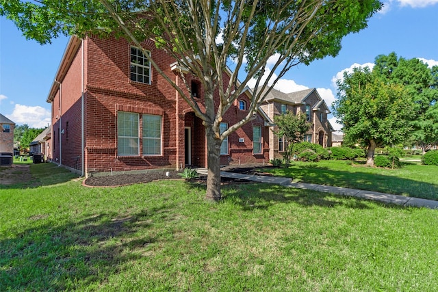 2442 Mackinac Dr, Frisco, TX 75033 - view of front of home with brick siding, a front yard, and central AC