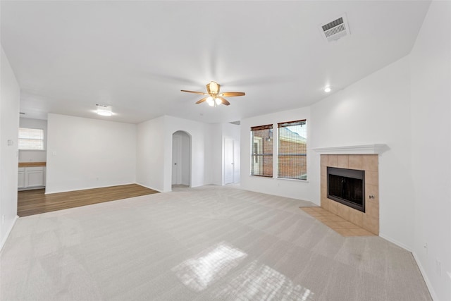 2442 Mackinac Dr, Frisco, TX 75033 - unfurnished living room featuring light colored carpet, arched walkways, and plenty of natural light