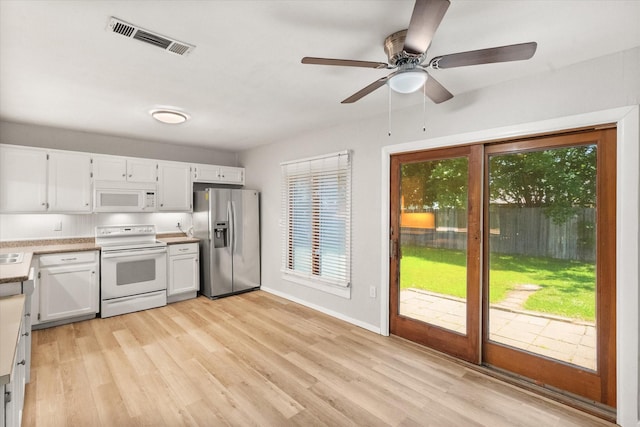 603 Plainview Dr, Mansfield, TX 76063 - kitchen with white appliances, light wood-type flooring, light countertops, and white cabinets