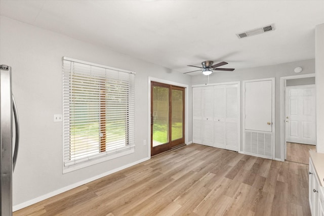 603 Plainview Dr, Mansfield, TX 76063 - unfurnished bedroom with freestanding refrigerator, baseboards, light wood-type flooring, ceiling fan, and access to exterior