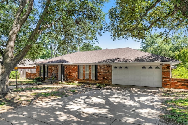 1706 Kingsborough Dr, Arlington, TX 76015 - ranch-style house with brick siding, concrete driveway, a garage, and roof with shingles
