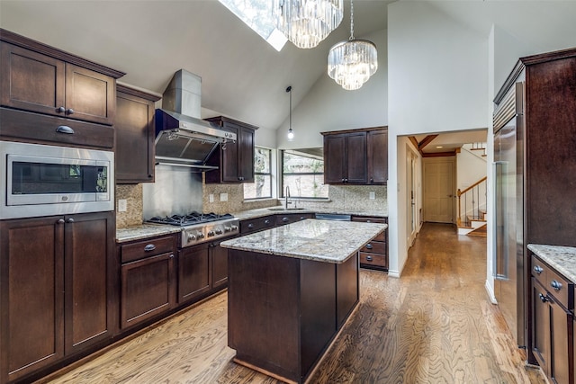 18602 Turnbridge Dr, Dallas, TX 75252 - kitchen with built in appliances, wall chimney exhaust hood, light wood finished floors, high vaulted ceiling, and a sink