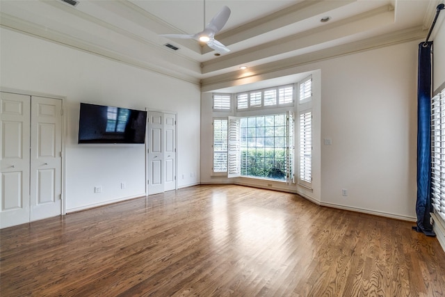 18602 Turnbridge Dr, Dallas, TX 75252 - unfurnished living room featuring crown molding, wood finished floors, a ceiling fan, a tray ceiling, and baseboards