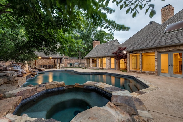 18602 Turnbridge Dr, Dallas, TX 75252 - view of swimming pool with french doors, a pool with connected hot tub, and a patio