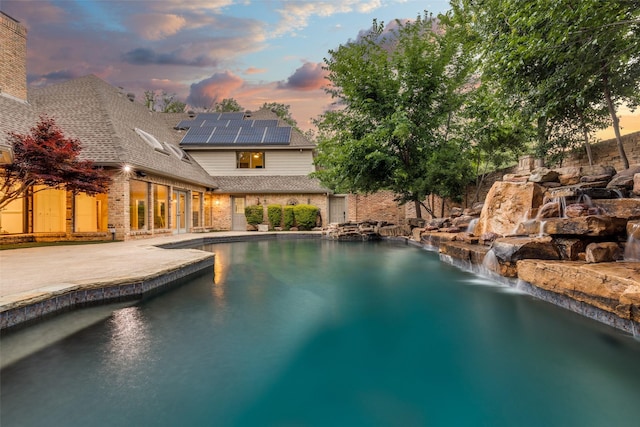 18602 Turnbridge Dr, Dallas, TX 75252 - pool at dusk with an outdoor pool and a patio area