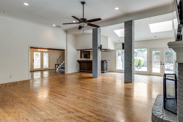 18602 Turnbridge Dr, Dallas, TX 75252 - unfurnished living room with a multi sided fireplace, stairs, healthy amount of natural light, french doors, and crown molding