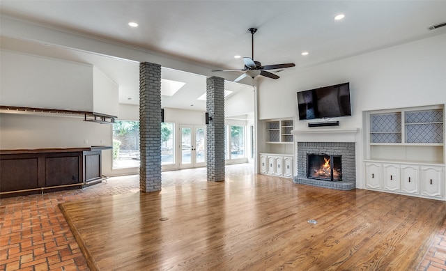 18602 Turnbridge Dr, Dallas, TX 75252 - unfurnished living room with decorative columns, ceiling fan, recessed lighting, a brick fireplace, and a high ceiling