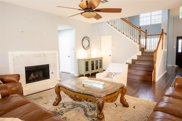1421 Eugene Dr, Wylie, TX 75098 - living room with hardwood / wood-style flooring, a ceiling fan, stairway, baseboards, and a premium fireplace