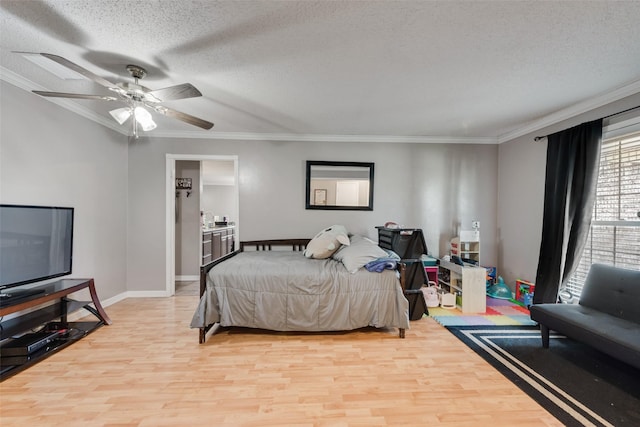 2900 Lachelle Ln, Arlington, TX 76010 - bedroom with light wood finished floors, ornamental molding, a textured ceiling, baseboards, and a ceiling fan