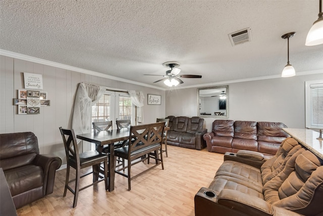 2900 Lachelle Ln, Arlington, TX 76010 - living room with light wood-style floors, ornamental molding, ceiling fan, and a textured ceiling
