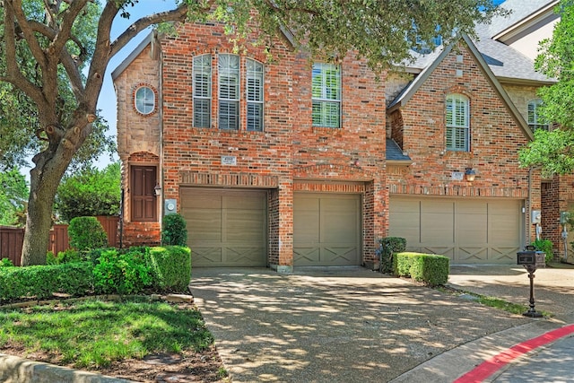 4160 Towne Green Cir, Addison, TX 75001 - view of front of house with a garage, driveway, and brick siding