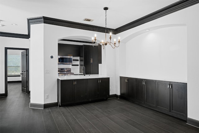 4160 Towne Green Cir, Addison, TX 75001 - kitchen with appliances with stainless steel finishes, dark cabinets, ornamental molding, arched walkways, and a sink