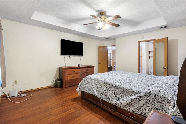 4206 Windhurst Dr, Arlington, TX 76015 - bedroom featuring a raised ceiling, wood finished floors, baseboards, and a ceiling fan