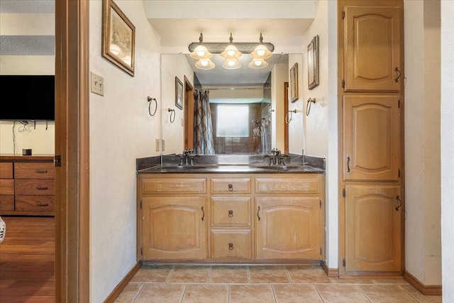 4206 Windhurst Dr, Arlington, TX 76015 - bathroom featuring double vanity and baseboards