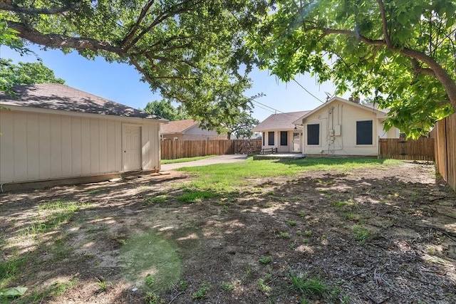 4206 Windhurst Dr, Arlington, TX 76015 - fenced backyard featuring a patio area and an outbuilding