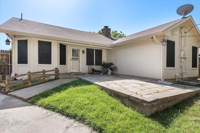 4206 Windhurst Dr, Arlington, TX 76015 - back of property featuring a chimney, a patio area, and roof with shingles