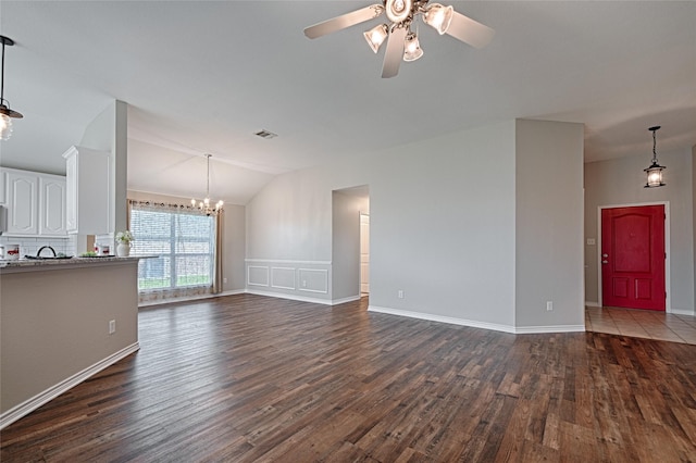 1223 Hampton Bay Dr, Rockwall, TX 75087 - unfurnished living room featuring lofted ceiling, dark wood-style floors, a chandelier, ceiling fan, and baseboards