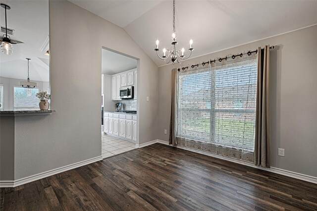 1223 Hampton Bay Dr, Rockwall, TX 75087 - unfurnished dining area featuring a chandelier, wood finished floors, lofted ceiling, and baseboards