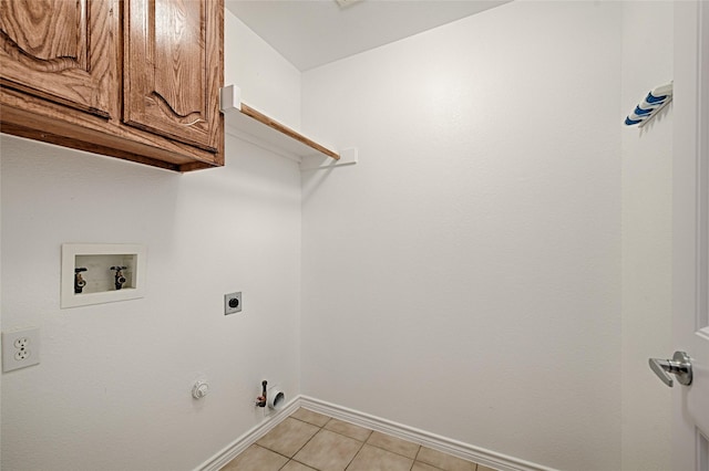 1223 Hampton Bay Dr, Rockwall, TX 75087 - washroom featuring hookup for a washing machine, electric dryer hookup, gas dryer hookup, cabinet space, and light tile patterned flooring