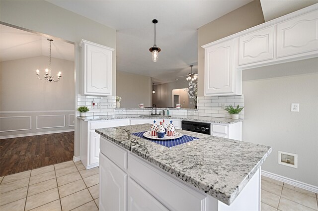 1223 Hampton Bay Dr, Rockwall, TX 75087 - kitchen featuring ceiling fan, a chandelier, decorative backsplash, light tile patterned floors, and a center island