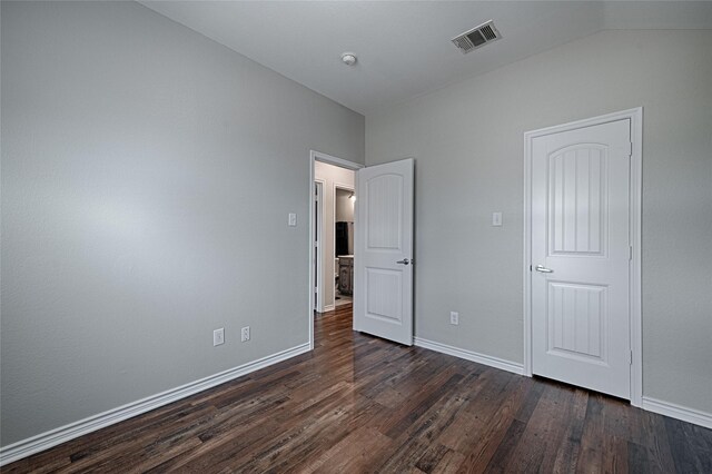 1223 Hampton Bay Dr, Rockwall, TX 75087 - unfurnished bedroom with dark wood finished floors, vaulted ceiling, and baseboards