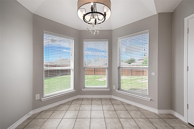 1223 Hampton Bay Dr, Rockwall, TX 75087 - unfurnished dining area featuring a chandelier, light tile patterned floors, and baseboards