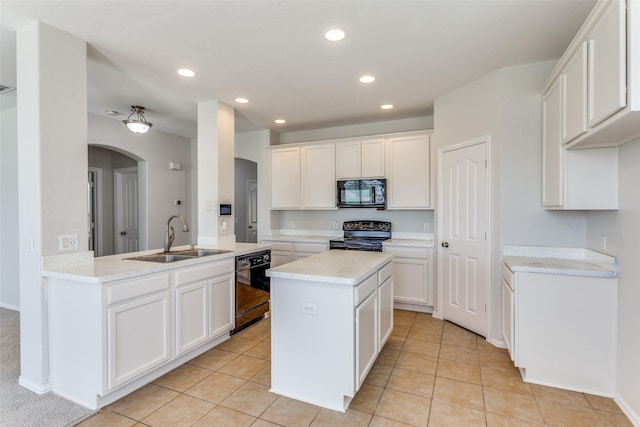 536 Kerry St, Crowley, TX 76036 - kitchen with black appliances, a sink, arched walkways, recessed lighting, and light countertops
