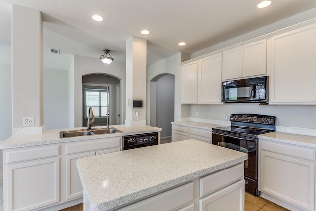 536 Kerry St, Crowley, TX 76036 - kitchen with black appliances, arched walkways, a sink, white cabinetry, and recessed lighting