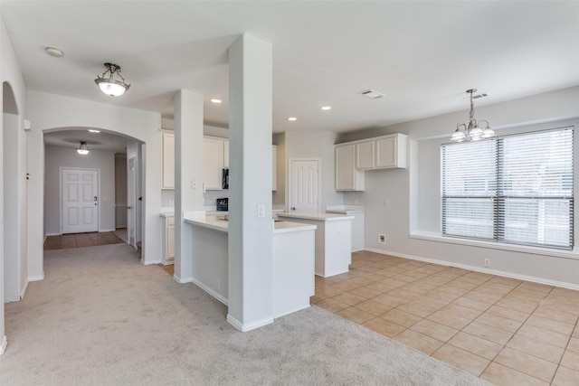 536 Kerry St, Crowley, TX 76036 - kitchen with arched walkways, white cabinetry, light tile patterned flooring, light carpet, and recessed lighting