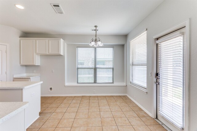 536 Kerry St, Crowley, TX 76036 - kitchen with pendant lighting, white cabinets, a chandelier, baseboards, and light stone counters