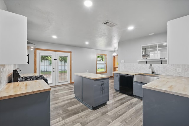 1317 Elby St, Irving, TX 75061 - kitchen with wood counters, black appliances, decorative backsplash, light wood-style floors, and recessed lighting