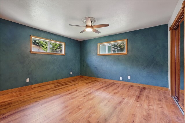 1317 Elby St, Irving, TX 75061 - spare room with a ceiling fan, wood finished floors, and baseboards