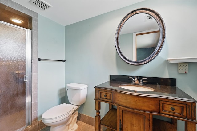 1317 Elby St, Irving, TX 75061 - bathroom with a shower stall, toilet, vanity, tile patterned flooring, and baseboards