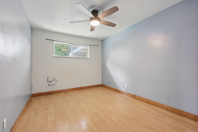1317 Elby St, Irving, TX 75061 - empty room with wood finished floors, ceiling fan, and baseboards