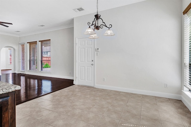 2353 Salisbury Ct, The Colony, TX 75056 - unfurnished dining area featuring arched walkways, plenty of natural light, light tile patterned floors, and crown molding