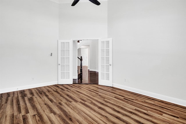 2353 Salisbury Ct, The Colony, TX 75056 - spare room featuring french doors, wood finished floors, baseboards, a ceiling fan, and a towering ceiling