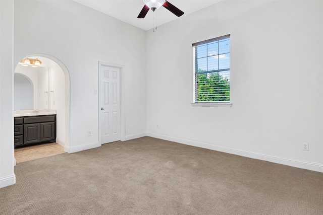 2353 Salisbury Ct, The Colony, TX 75056 - unfurnished bedroom featuring light colored carpet, arched walkways, connected bathroom, and baseboards
