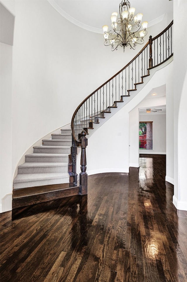 2353 Salisbury Ct, The Colony, TX 75056 - stairs featuring wood finished floors, a chandelier, baseboards, a high ceiling, and crown molding