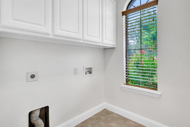 2353 Salisbury Ct, The Colony, TX 75056 - laundry area featuring hookup for an electric dryer, baseboards, washer hookup, cabinet space, and light tile patterned floors