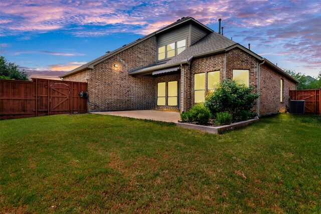 2353 Salisbury Ct, The Colony, TX 75056 - rear view of house featuring a gate, brick siding, a patio area, and central AC unit