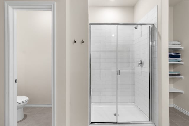 1304 Villalonga Dr, Little Elm, TX 75068 - bathroom with toilet, a stall shower, tile patterned floors, and baseboards