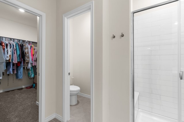 1304 Villalonga Dr, Little Elm, TX 75068 - bathroom with a stall shower, a walk in closet, toilet, and baseboards