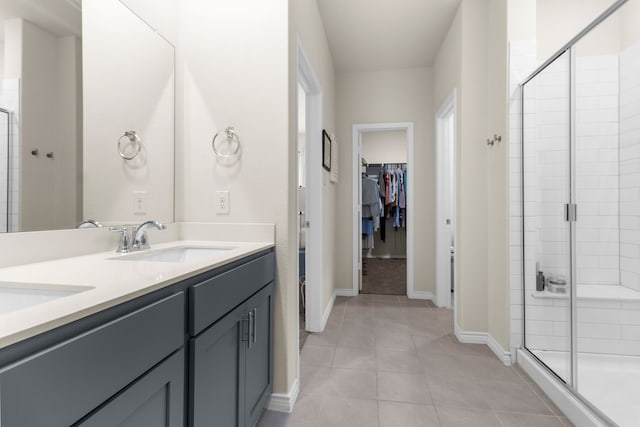 1304 Villalonga Dr, Little Elm, TX 75068 - full bathroom with a shower stall, a walk in closet, double vanity, and tile patterned flooring