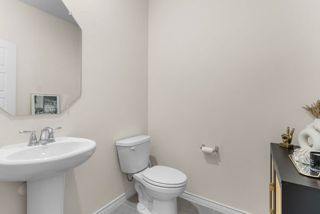 1304 Villalonga Dr, Little Elm, TX 75068 - half bathroom with toilet, tile patterned flooring, baseboards, and a sink